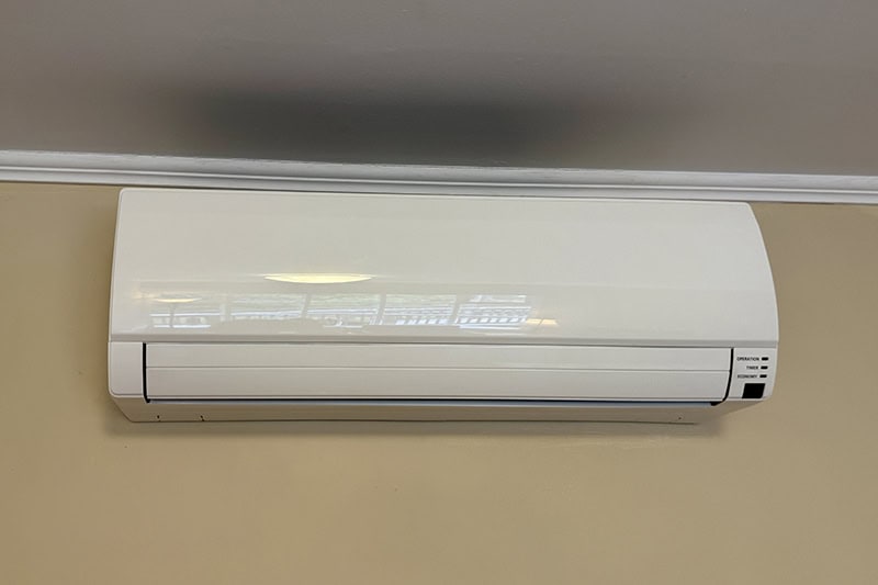 A close-up shot of an indoor mini-split air conditioning unit mounted on a wall.