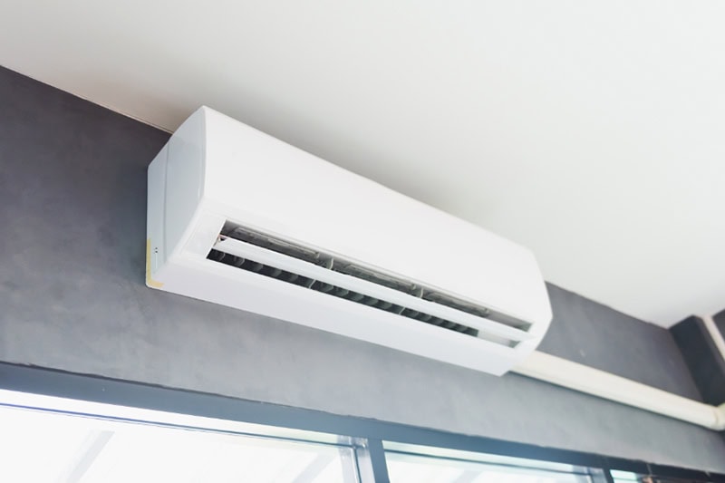 Why Are They Called Ductless Mini Splits? Cool air conditioner swing system on wall in room